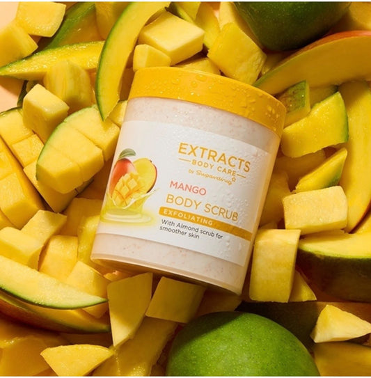 Superdrug Extracts Mango Body Scrub surrounded by mango pieces